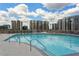 Rooftop pool with city views, sundeck, and comfortable lounge chairs at 860 Peachtree Ne St # 2209, Atlanta, GA 30308
