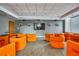 A community theater room featuring orange chairs and a large screen for viewing at 860 Peachtree Ne St # 2209, Atlanta, GA 30308