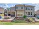 Spacious backyard with a covered patio, hot tub, dining area, and manicured landscaping at 1074 Nash Springs Cir, Lilburn, GA 30047