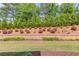 Beautifully landscaped backyard with tiered garden beds, lush green lawn, and manicured shrubbery at 1074 Nash Springs Cir, Lilburn, GA 30047