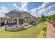 Expansive backyard with covered patio, hot tub, outdoor seating area, and beautifully landscaped garden beds at 1074 Nash Springs Cir, Lilburn, GA 30047