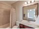 Ensuite bathroom with a shower/tub combo, a large mirror, and a vanity at 1074 Nash Springs Cir, Lilburn, GA 30047