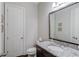 Bathroom features a vanity with granite countertop, a sink, a mirror, and a toilet at 1074 Nash Springs Cir, Lilburn, GA 30047