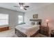 Cozy carpeted bedroom has a ceiling fan, queen sized bed and two large windows at 1074 Nash Springs Cir, Lilburn, GA 30047