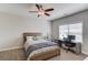 Bright bedroom with a ceiling fan, a desk, and a window that provides natural light at 1074 Nash Springs Cir, Lilburn, GA 30047