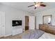 Bedroom features neutral paint, tv, and dresser that provides ample storage space at 1074 Nash Springs Cir, Lilburn, GA 30047