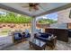 Relaxing covered patio with seating, a ceiling fan, and a view of the backyard at 1074 Nash Springs Cir, Lilburn, GA 30047