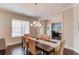 Traditional dining room with hardwood floors, chair rail, decorative chandelier, and views into a study at 1074 Nash Springs Cir, Lilburn, GA 30047