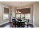 Cozy dining room with hardwood floors, modern chandelier, and large window offering natural light and pleasant views at 1074 Nash Springs Cir, Lilburn, GA 30047
