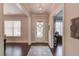 Elegant foyer with hardwood floors, neutral paint, and views of adjacent rooms and staircase at 1074 Nash Springs Cir, Lilburn, GA 30047