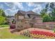 Enclave at Roswell Springs entrance surrounded by colorful flowerbeds and landscaping at 1074 Nash Springs Cir, Lilburn, GA 30047
