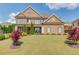 Beautiful brick home with well-manicured lawn, landscaping, symmetrical design and inviting covered entryway at 1074 Nash Springs Cir, Lilburn, GA 30047