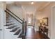 Inviting hallway features hardwood floors and decorative details leading to the front door and staircase at 1074 Nash Springs Cir, Lilburn, GA 30047