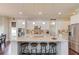 A gourmet kitchen featuring white cabinets, a large granite island with seating, and stainless steel appliances at 1074 Nash Springs Cir, Lilburn, GA 30047