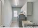 Convenient laundry room with built-in cabinets, a window, a sink and a washer/dryer at 1074 Nash Springs Cir, Lilburn, GA 30047
