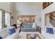 Bright living room featuring high ceilings, hardwood floors, neutral walls, and an open view to the kitchen at 1074 Nash Springs Cir, Lilburn, GA 30047