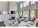Spacious living room with soaring ceilings, large windows, built-ins, and a fireplace at 1074 Nash Springs Cir, Lilburn, GA 30047
