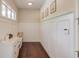 A well-organized mudroom featuring a white storage bench, cabinets, and a coat rack for added convenience at 1074 Nash Springs Cir, Lilburn, GA 30047