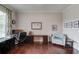 A well-lit home office with hardwood floors, offering a quiet and productive workspace with ample storage at 1074 Nash Springs Cir, Lilburn, GA 30047