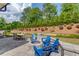 Inviting stone patio features an outdoor fireplace and Adirondack chairs, perfect for relaxing with a view at 1074 Nash Springs Cir, Lilburn, GA 30047