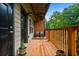 Cozy covered wooden balcony with outdoor seating, offering a relaxing view of trees and a stream at 1635 Briarcliff Rd # 8, Atlanta, GA 30306