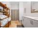 Bright bathroom with tiled floor, wooden storage shelves, white vanity and decorative shower curtain at 1635 Briarcliff Rd # 8, Atlanta, GA 30306