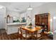 An open dining area features hardwood floors, a wood table with seating for six, and connects to the kitchen at 1635 Briarcliff Rd # 8, Atlanta, GA 30306