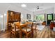 An open dining area features hardwood floors, a wood table with seating for six, and connects to the living room at 1635 Briarcliff Rd # 8, Atlanta, GA 30306