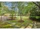 Landscaped backyard features a sprawling green lawn, decorative trees, and a stone path at 3818 Sweet Bottom Dr, Duluth, GA 30096