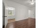View of a bathroom from a bedroom with hardwood floors, white walls, and ceiling fan at 3818 Sweet Bottom Dr, Duluth, GA 30096