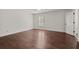 Spacious bedroom featuring hardwood floors, white walls, and natural light from a window at 3818 Sweet Bottom Dr, Duluth, GA 30096