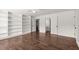 Bedroom featuring hardwood floors and extensive built-in bookshelves at 3818 Sweet Bottom Dr, Duluth, GA 30096