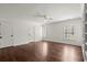 Bright bedroom with hardwood floors, two windows, ceiling fan, and integrated shelving at 3818 Sweet Bottom Dr, Duluth, GA 30096