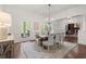 Elegant dining room with hardwood floors, white trim, and a large table with seating for six at 3818 Sweet Bottom Dr, Duluth, GA 30096