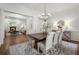 Elegant dining room features a modern chandelier, seating for six, and hardwood floors with open floor plan at 3818 Sweet Bottom Dr, Duluth, GA 30096