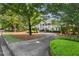 Classic home with green lawn, mature trees, and a long concrete driveway leading to the house at 3818 Sweet Bottom Dr, Duluth, GA 30096