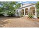 Exterior view featuring a long, white house with covered patio and stone driveway at 3818 Sweet Bottom Dr, Duluth, GA 30096