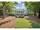 Beautiful home exterior with manicured lawn, mature trees, and a long driveway at 3818 Sweet Bottom Dr, Duluth, GA 30096