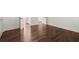 Hallway with hardwood floors, open doorways, and views into multiple rooms at 3818 Sweet Bottom Dr, Duluth, GA 30096