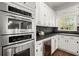 Modern kitchen boasts stainless steel appliances, sleek cabinets, and a built-in wine refrigerator at 3818 Sweet Bottom Dr, Duluth, GA 30096