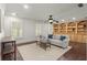 Beautiful living room with hardwood floors, white walls, built-ins, ceiling fan, and lots of light at 3818 Sweet Bottom Dr, Duluth, GA 30096