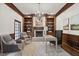 Charming home office with wood trim, built in shelves, a fireplace, and a large window at 3818 Sweet Bottom Dr, Duluth, GA 30096