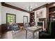 Charming home office with wood trim, built in shelves, a fireplace, and a large window at 3818 Sweet Bottom Dr, Duluth, GA 30096