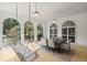 Charming covered patio with dining table and porch swing offering serene outdoor dining space at 3818 Sweet Bottom Dr, Duluth, GA 30096