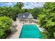 Aerial view of an in-ground pool with a covered porch area and travertine deck at 3818 Sweet Bottom Dr, Duluth, GA 30096