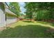 Expansive backyard featuring lush green grass, a sturdy wooden fence, and mature trees providing shade and privacy at 4872 Nature Trl, Austell, GA 30106