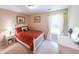 Cozy bedroom with a red patterned bed, and a white vanity beneath a window at 4872 Nature Trl, Austell, GA 30106