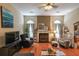 Relaxing living room featuring a fireplace, hardwood floors, and an array of windows that flood the space with natural light at 4872 Nature Trl, Austell, GA 30106