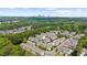 Scenic aerial view of townhomes nestled amongst lush greenery with the city skyline in the background at 1381 Wallace Walk, Atlanta, GA 30316