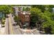 Aerial shot highlights a corner building nestled among trees and streets, showcasing its unique positioning at 1381 Wallace Walk, Atlanta, GA 30316